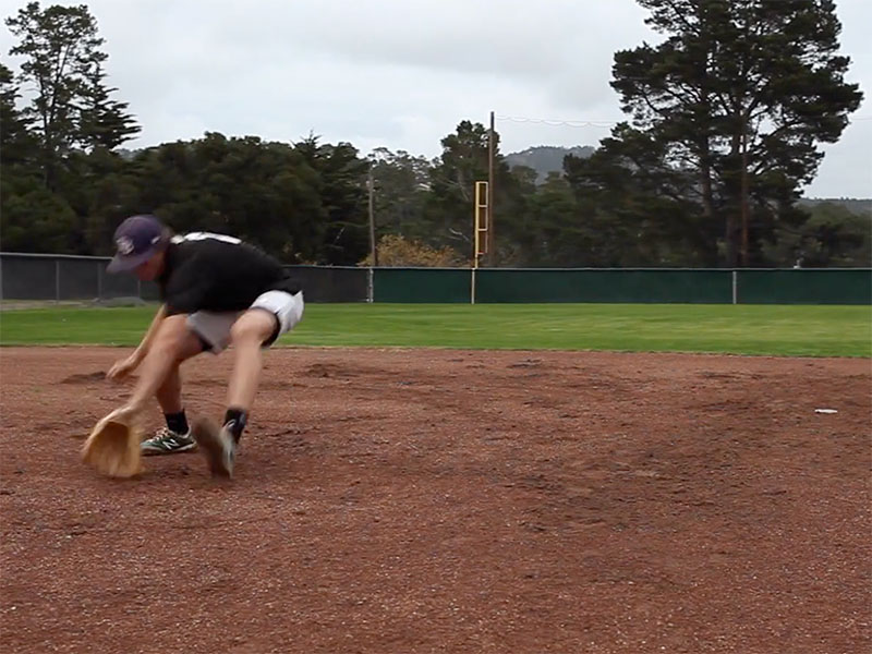 player fielding grounder backhanded