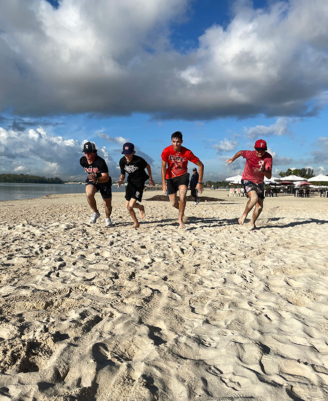 Players running on beach